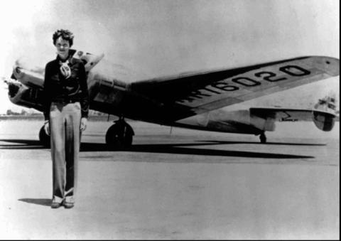 Amelia Earhart in front of a plane