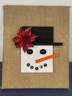 Hand-crafted snowman on burlap background