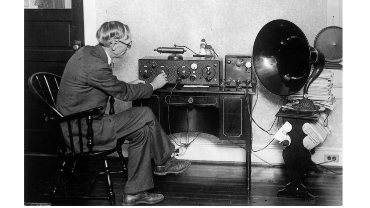 Man in front of old radio