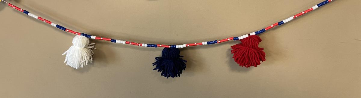 patriotic banner made of yarn and beads