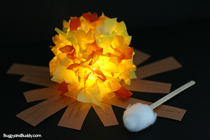 A small craft campfire made of tissue paper, construction paper, a tea light, and a cotton ball.